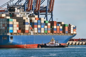 Huge container ship in port being loaded