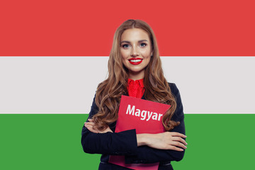 Happy student girl against the Hungary flag background. Study hu