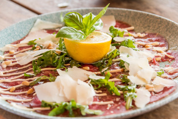 White dish with carpaccio of beef
