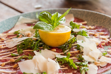 White dish with carpaccio of beef