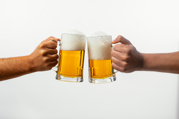 Hands toasting with beer on white background
