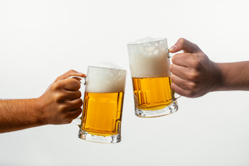 Hands toasting with beer on white background