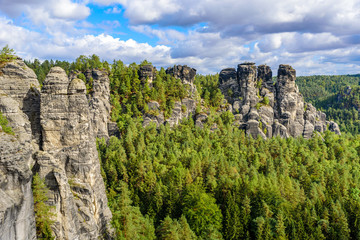 Fototapeta na wymiar Bastei - View of beautiful rock formation in Saxon Switzerland National Park from the Bastei bridge - Elbe Sandstone Mountains near Dresden and Rathen - Germany. Popular travel destination in Saxony.