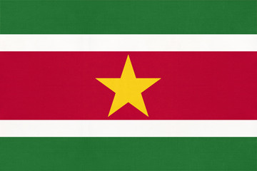 Suriname national fabric flag, textile background. Symbol of south america world country.