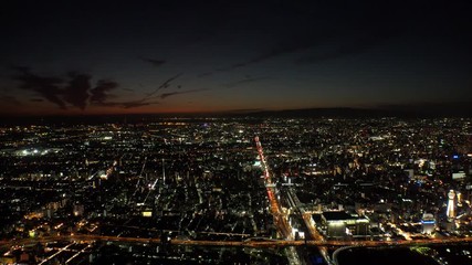 OSAKA, JAPAN - CIRCA SEPTEMBER 2019 : Aerial high angle view of CITYSCAPE of OSAKA in night time. Osaka is the second largest metropolitan area in Japan.
