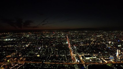 OSAKA, JAPAN - CIRCA SEPTEMBER 2019 : Aerial high angle view of CITYSCAPE of OSAKA in night time. Osaka is the second largest metropolitan area in Japan.