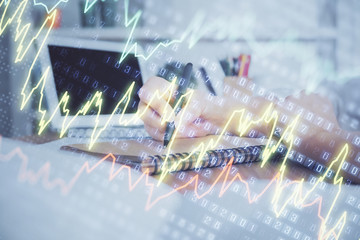 Financial graph displayed on woman's hand taking notes background. Concept of research. Double exposure