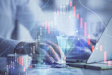 Double exposure of forex graph with man working on computer on background. Concept of market analysis.