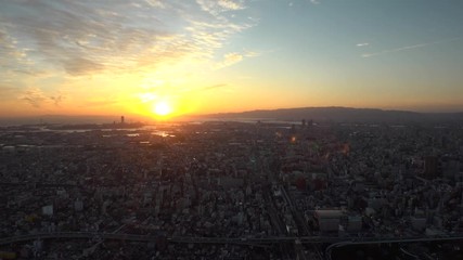 OSAKA, JAPAN - CIRCA SEPTEMBER 2019 : Aerial high angle view of CITYSCAPE of OSAKA. Time lapse shot, sunset to night. Osaka is the second largest metropolitan area in Japan.