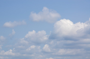 White clouds in front of a blue sky
