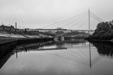 Pedestrian bridge over the river on the city background. River embankment.8