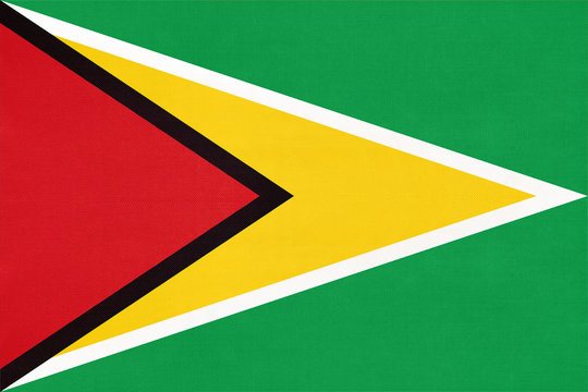 Guyana national fabric flag, textile background. American state official sign.