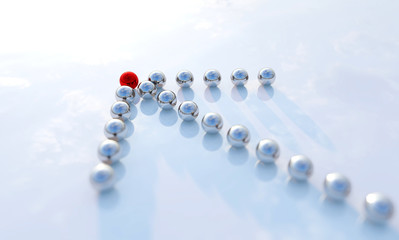 Concept or conceptual row of balls in form of an arrow with a red one standing out on blue background as a metaphor for creativity and leadership. A courage, action and success 3d illustration