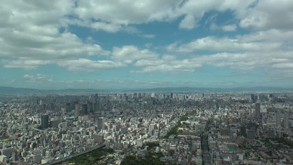 OSAKA, JAPAN - CIRCA SEPTEMBER 2019 : Aerial high angle view of CITYSCAPE of OSAKA in daytime. Osaka is the second largest metropolitan area in Japan. Time lapse shot.
