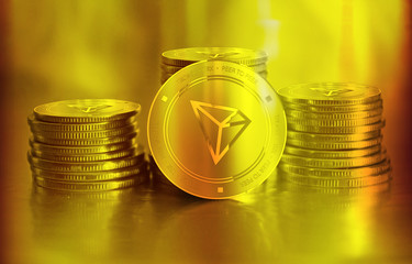 Tronix (TRX) digital crypto currency. Stack of golden coins. Cyber money.