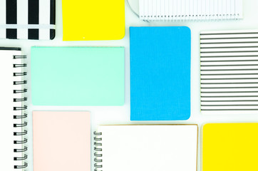 Top view School supplies on white. Notepads, and spiral notebooks pattern