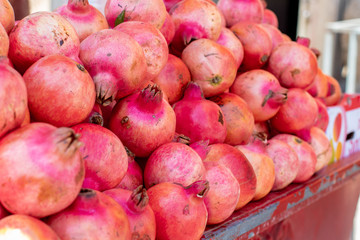a lot of fresh pomegranates in the market