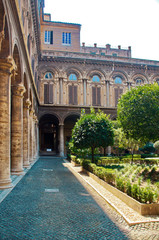 A well-kept green courtyard with trees and a fountain in the Doria Pamphili Gallery at Via del...