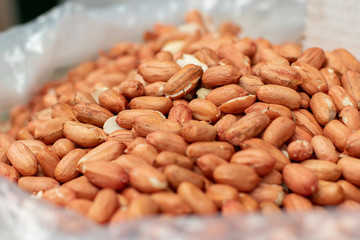 unshelled peanuts in a polythene bag on the market