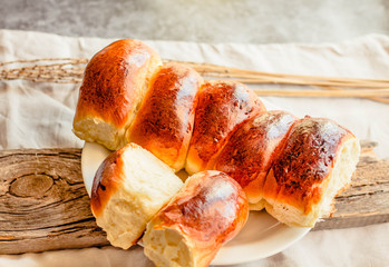 Homemade patties on white linen tablecloth background. Russian pirozhki. Traditional pastry. Baked dough in oven.Holiday and comfort food concept