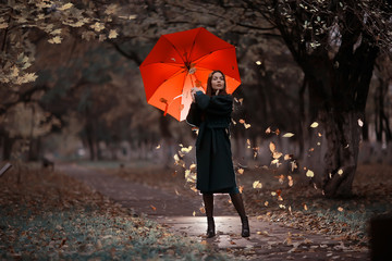 autumn evening woman holds umbrella, october in dark city park, young lonely model with umbrella