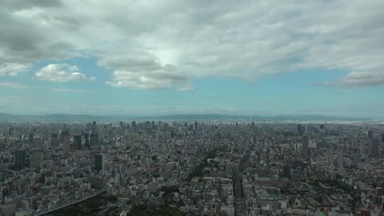OSAKA, JAPAN - CIRCA SEPTEMBER 2019 : Aerial high angle view of CITYSCAPE of OSAKA in daytime. Osaka is the second largest metropolitan area in Japan. Time lapse shot.