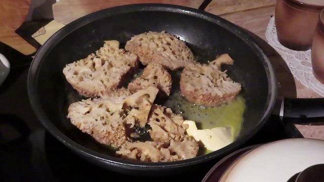 cauliflower fungus (Sparassis crispa). roast mushroom in pan with butter.