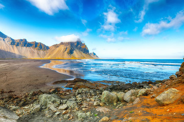 Fantastic sunny day and dramatic black sand beach on Stokksnes cape in Iceland.