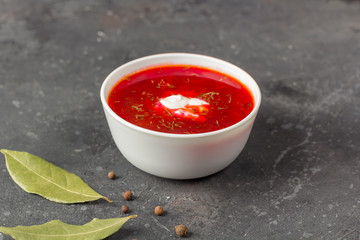 Vegetarian borsch in a bowl. Plate of beetroot soup on a black background. Traditional Ukraine Russian food cuisine. The concept of vegetarian and organic foods.