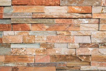 Grunge brown ,beige,orange,grey stone wall tiles texture backdrop.Wall natural brown stone dirty,dust.Wall and panel marble natural pattern for architecture and interior design or abstract background