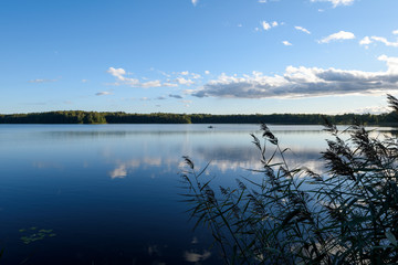 Sunset on the lake. Beautiful sunset nature. Evening landscape. Clouds over the lake.
