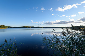 Sunset on the lake. Beautiful sunset nature. Evening landscape. Clouds over the lake.