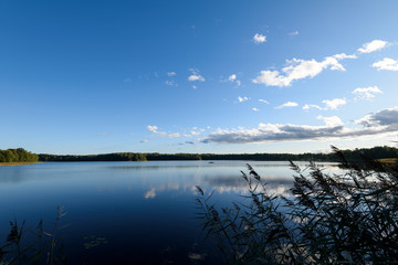 Sunset on the lake. Beautiful sunset nature. Evening landscape. Clouds over the lake.