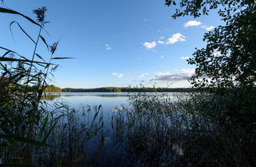 Sunset on the lake. Beautiful sunset nature. Evening landscape. Clouds over the lake.