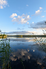 Sunset on the lake. Beautiful sunset nature. Evening landscape. Clouds over the lake.