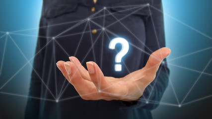 Businesswoman on blurred background using question mark