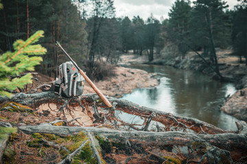 Fishing equipment close-up on the riverbank.