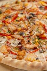 Hot chicken pizza with mushrooms and bell pepper with a thick crust in a delivery box
