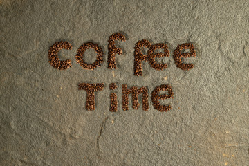 English Coffee Alphabet on stone background. Roasted coffee beans.