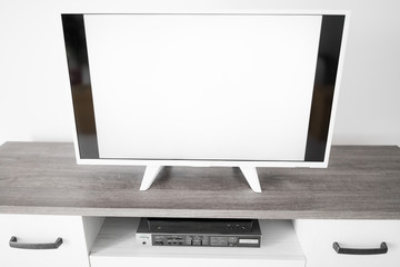 TV with white screen on a stand in the room.
