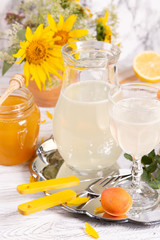 Refreshing drink with lemon and honey on a tray