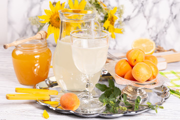 Refreshing drink with lemon and honey on a tray