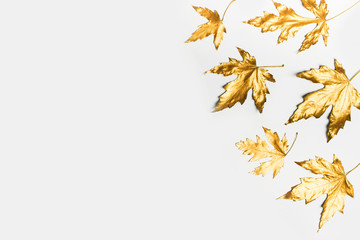 Fall and autumn flat lay with painted golden leaves on white background