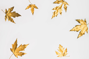 Fall and autumn flat lay with painted golden leaves on white background