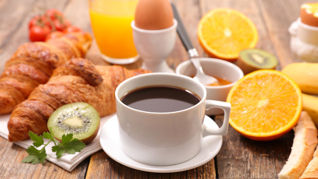 continental breakfast, coffee cup, croissant, egg and orange juice