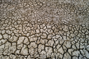 Dry lake bed with natural texture of cracked clay in perspective floor