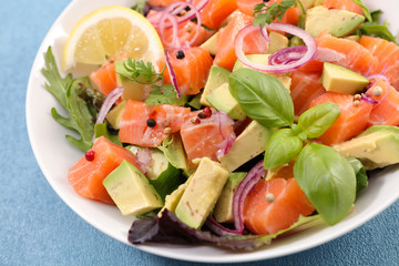 bowl of salad with avocado, salmon and basil