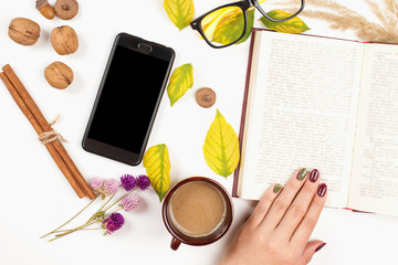 Time for reading. Autumn background with opened book, cup of coffee. Autumn mood, lifestyle, season. Autumn flat lay.