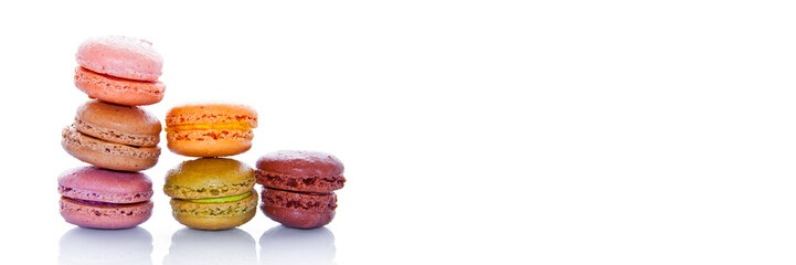 Pyramid of pastel colored french macarons, isolated on panoramic white background