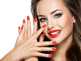 beautiful smiling woman with red nails